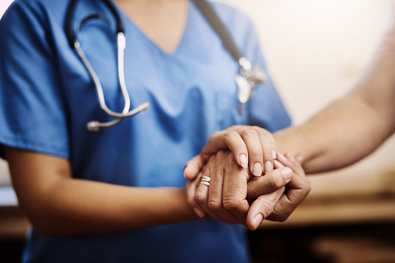 You dont have to face your challenges alone. Cropped shot of an unrecognizable female nurse holding a senior womans hands in comfort.