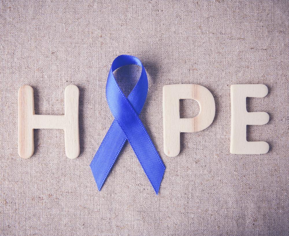 Blue ribbon with HOPE word, toning background, Colon Cancer, Colorectal Cancer awareness