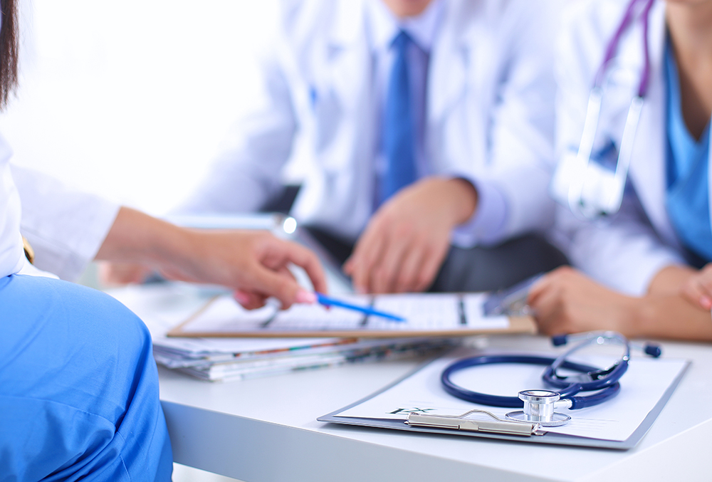 Happy medical team discussing and working together Happy medical team discussing and working together