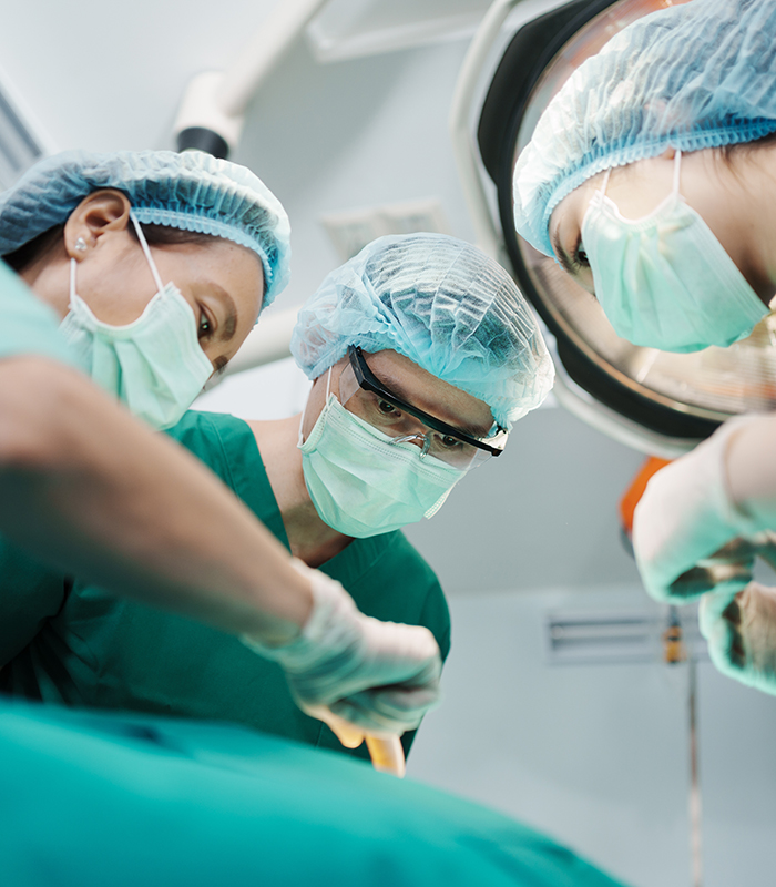 Low Angle Shot of Professional surgeons team performing surgery