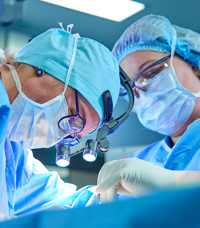 A surgeon's team in uniform performs an operation on a patient at a cardiac surgery clinic. Modern medicine, a professional team of surgeons, health.